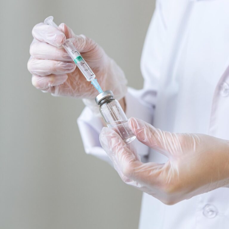 side-view-female-researcher-with-gloves-holding-syringe